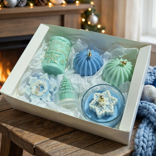 Decorative candles in a box with Christmas-themed design on a wooden surface.